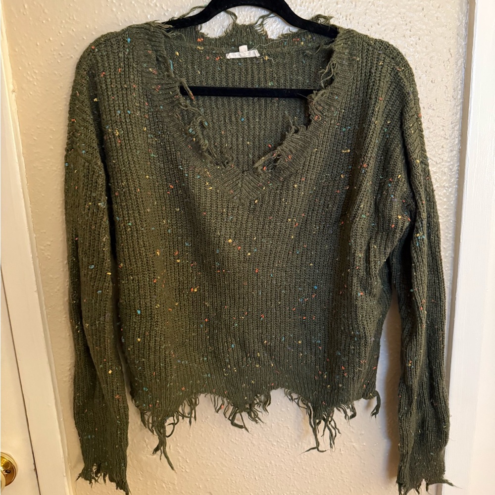 Green sweater with multiple colored dots
